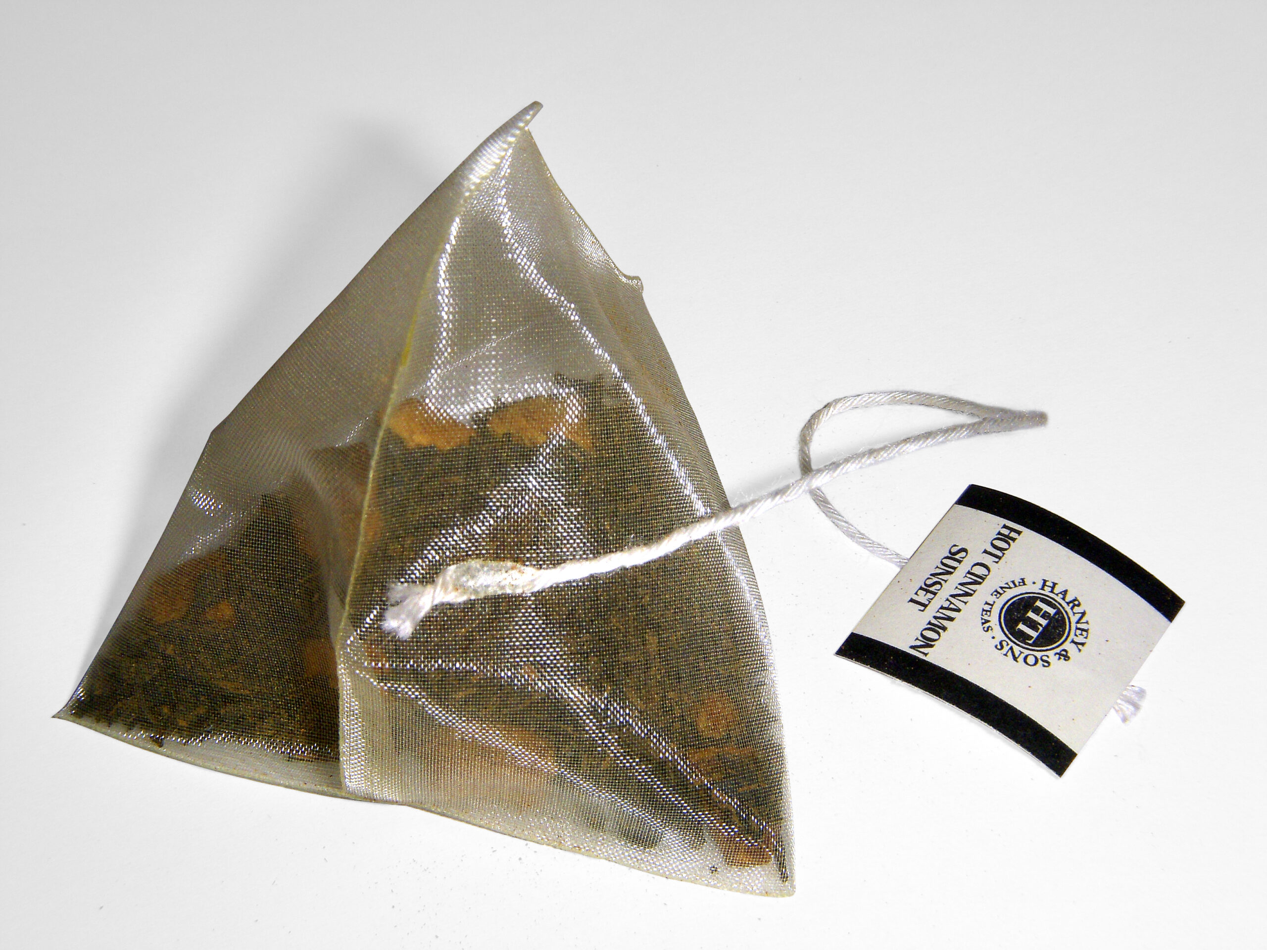A single silken pyramidal tea bag with string and tag — the form-factor Mighty Leaf helped popularise in the late 1990s foodservice channel.