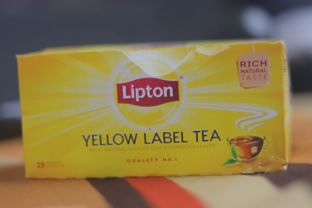 A yellow box of Lipton Yellow Label tea bags with the red Lipton shield logo.