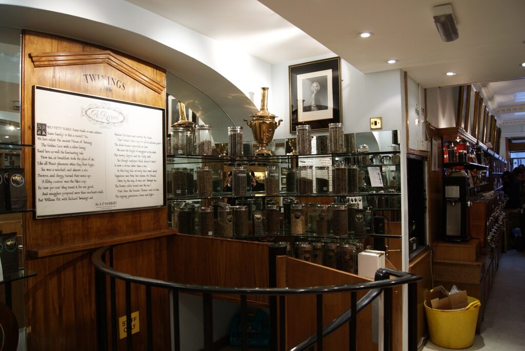 Rows of glass tea sample jars on wooden shelves inside the Twinings shop on the Strand, London.