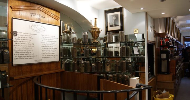 Rows of glass tea sample jars on wooden shelves inside the Twinings shop on the Strand, London.